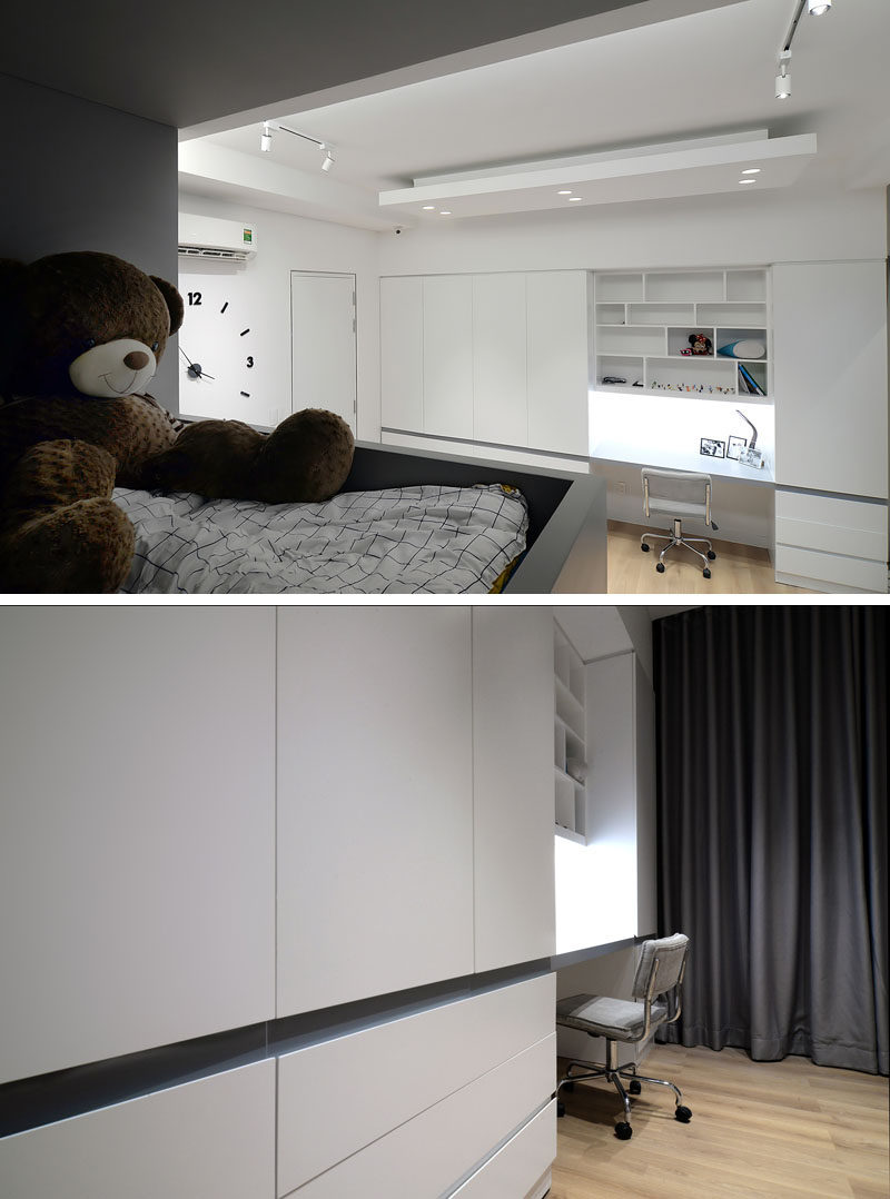This modern kids bedroom features a custom designed built-in bunk bed with stairs, and a wall full of closets with space for a study area. #KidsBedroom #BunkBeds #BuiltInBed #Closets