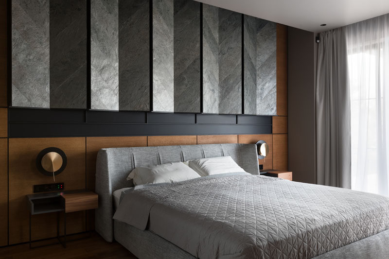 In this modern master bedroom, grey tiles installed in a chevron pattern, have been angled to create a unique wall feature above the bed. #MasterBedroom #BedroomDesign #WallAccent