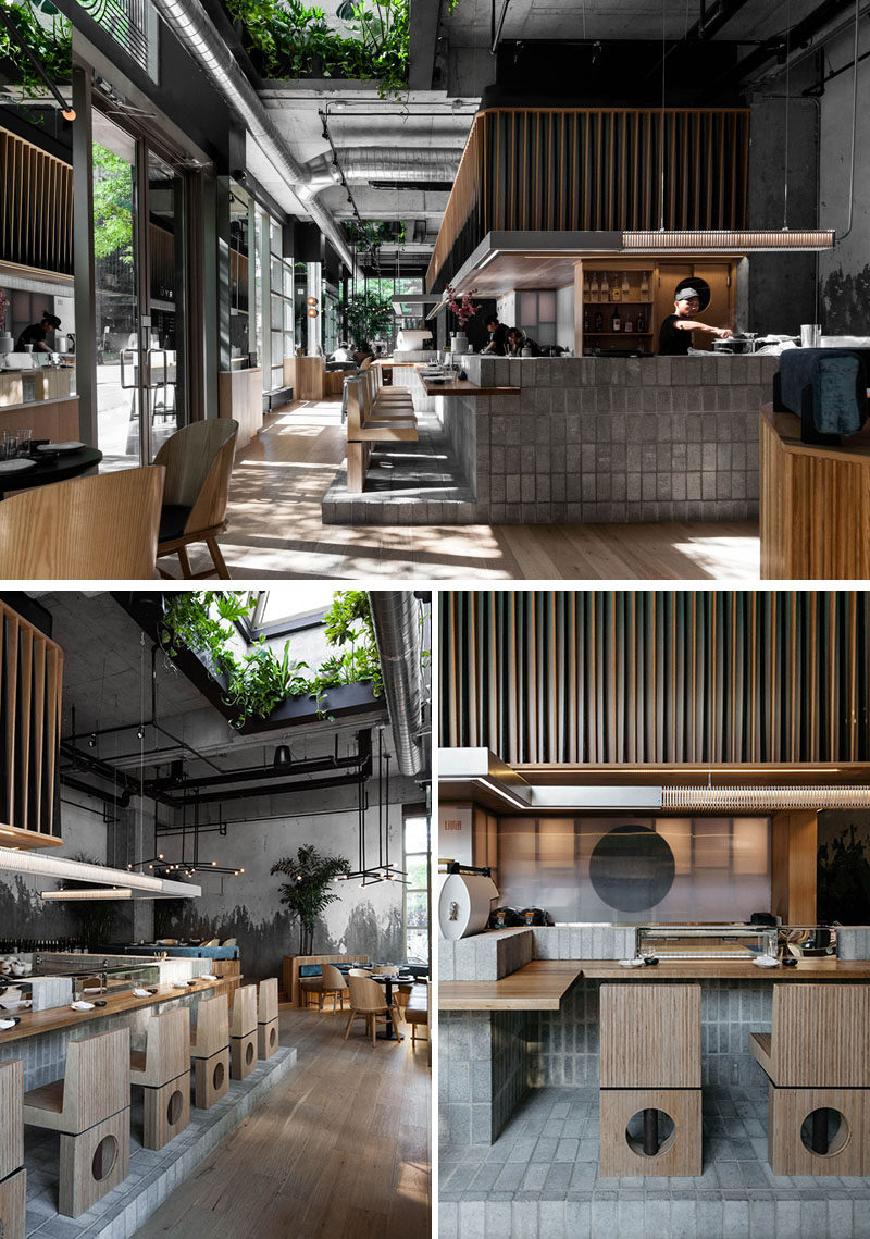 Translucent polycarbonate panels have been used to divide this modern restaurant kitchen from the sushi bar, creating a lantern effect at night and showing hints of the action happening within. #RestaurantDesign #SushiBar
