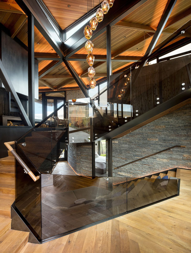 A wood staircase connects the levels of this modern mountain house. #ModernStairs #StairDesign #Staircase