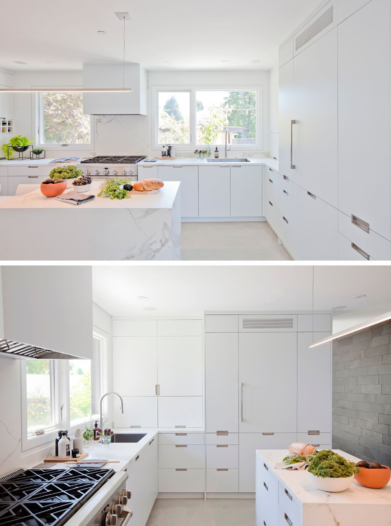 This modern kitchen is bright and airy due to the use of minimalist white cabinetry, lighting and the natural lighting from the windows. #WhiteKitchen #KitchenDesign