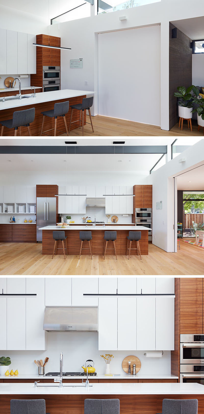 A sliding door can close off the playroom from the main social areas of the house. In the kitchen, white minimalist cabinets have been paired with wood elements. #ModernKitchen #KitchenDesign #WoodAndWhiteKitchen