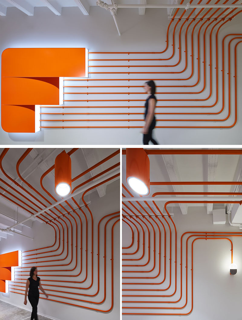 Studio BV have designed the Field Nation offices that were inspired by a circuit board and features orange conduit piping throughout, guiding people to the various areas of the office. #InteriorDesign #OfficeDesign #DesignAccent