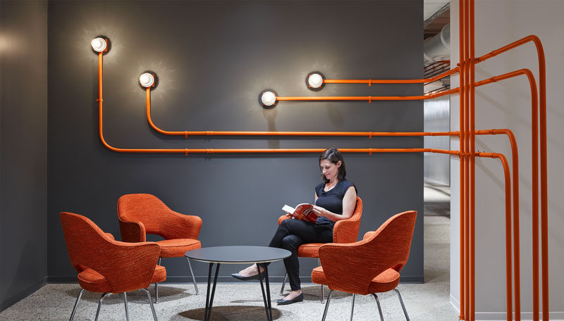 Studio BV have designed the Field Nation offices that were inspired by a circuit board and features orange conduit piping throughout, guiding people to the various areas of the office. #InteriorDesign #OfficeDesign #DesignAccent