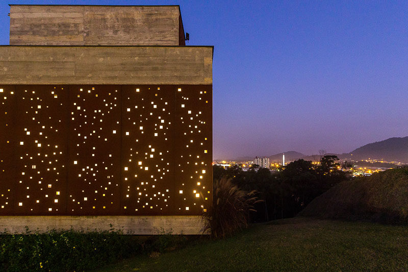 PJV Arquitetura have designed a modern concrete house that has an artistic perforated weathering steel screen to provide privacy and shade. #Architecture #WeatheringSteel #SteelScreen