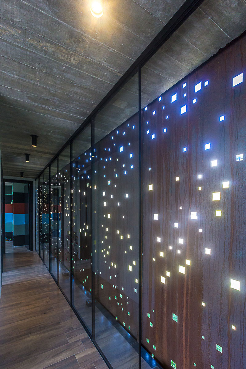 PJV Arquitetura have designed a modern concrete house that has an artistic perforated weathering steel screen to provide privacy and shade. #Architecture #WeatheringSteel #SteelScreen