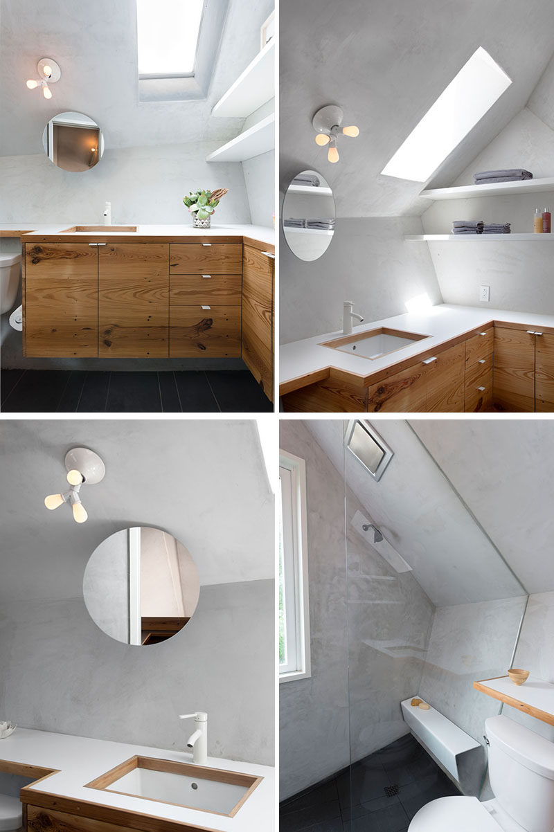 A skylight helps to brighten this small bathroom and add natural light, while a floating mirror is located above the vanity, and in the shower, there's a floating shower bench. #ModernBathroom #BathroomDesign #Skylight