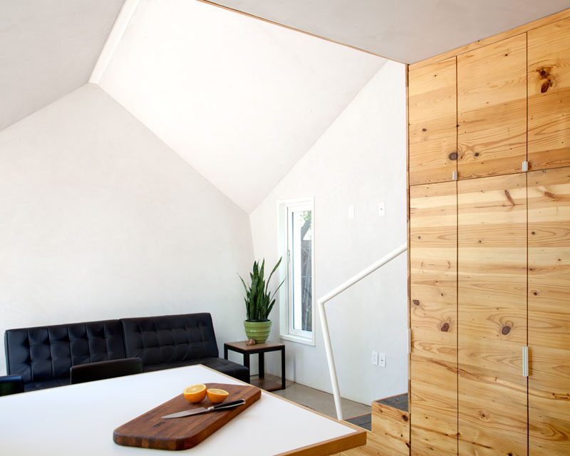 The interior of this apartment features bright white walls and longleaf pine cabinetry. #InteriorDesign #WoodCabinetry