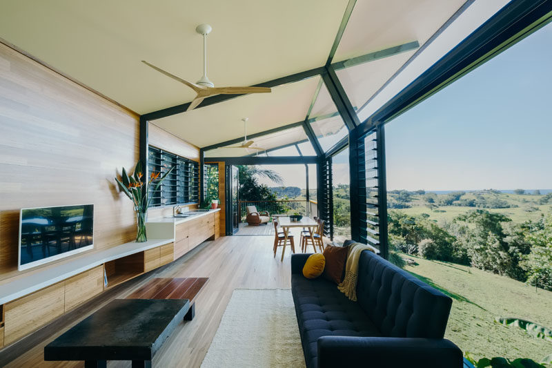 The social areas of this modern guest pavilion are open plan with the living room at one end, the kitchen and dining area in the middle, and a balcony at the other end. #GuestHouse #ModernInteriorDesign