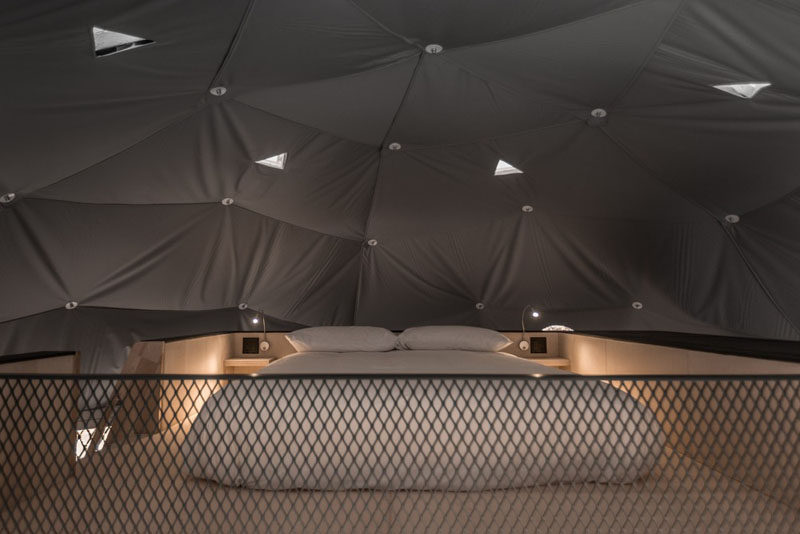 This dome has a boat staircase that leads to a second bed on a wood platform. #PlatformBed #Dome