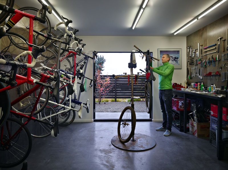 This modern house has a dedicated bike workshop for the storage and maintenance of the client's 18 bikes. #Bikes #Workshop