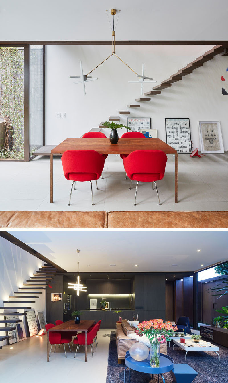 Bright red dining chairs and blue side tables add pops of color to this modern living room and dining room. #InteriorDesign #DiningRoom #LivingRoom