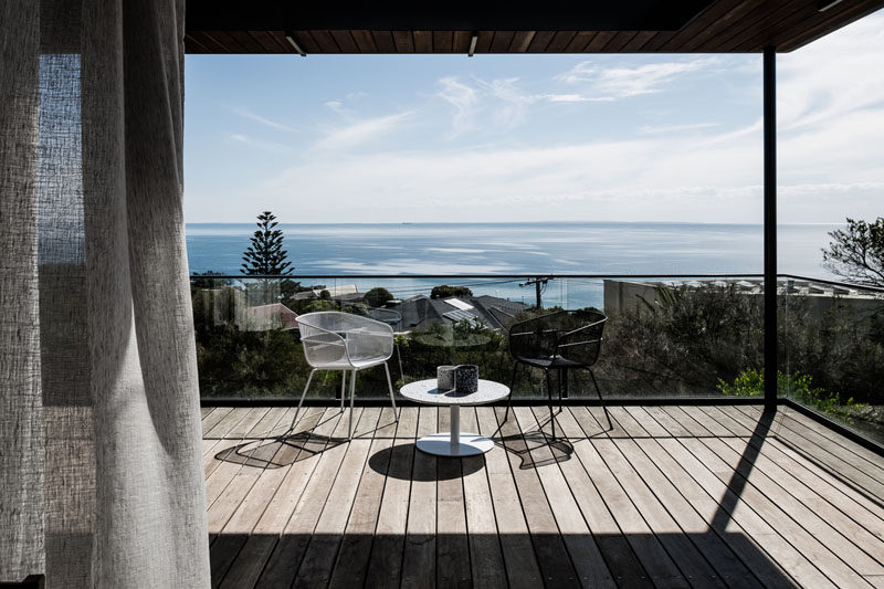 This modern house has a covered balcony that overlooks the neighborhood and has views of the ocean. #Balcony