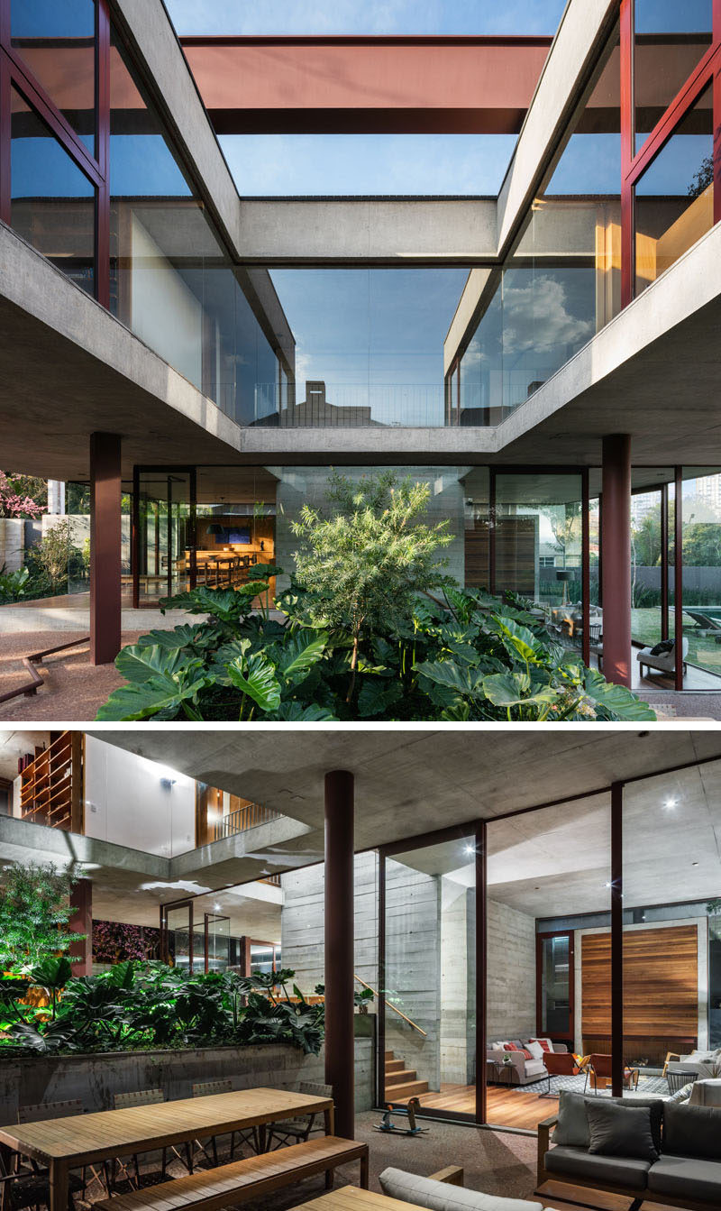 This modern house has a small set of stairs that lead from the dining room and kitchen, past a garden outside, and down to the living room. #Architecture #Concrete #Steel