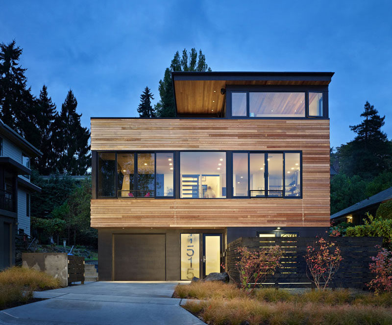 The exterior of this modern home features clear, unfinished Western Red Cedar that's been combined with painted Hardiepanel siding. The natural finish of the cedar will grey over time. #ModernHouse #ModernArchitecture #WoodSiding #CedarSiding