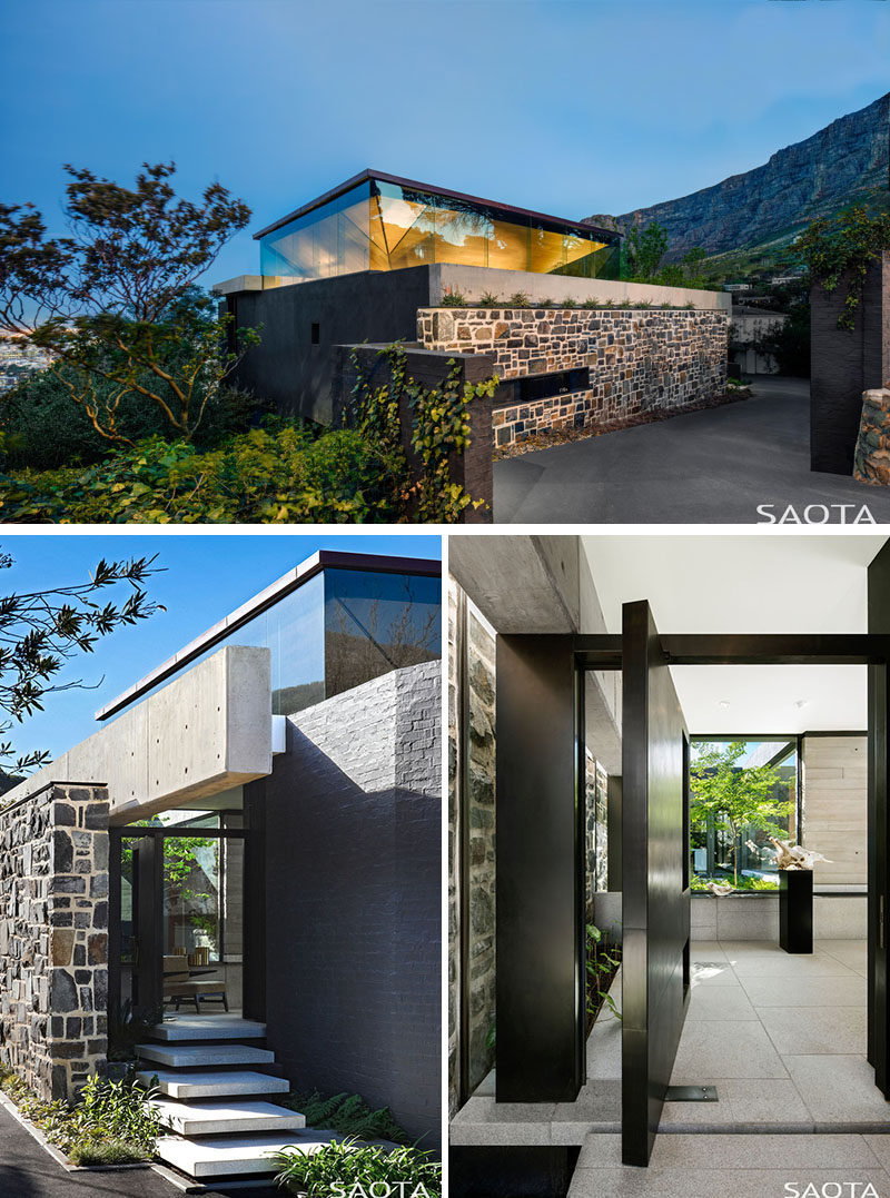 This modern house has been designed with an inverted pyramid roof, which creates a clerestory window around the upper level, while a large metal pivoting front door welcomes visitors to the home. #ModernHouse #Architecture #HouseDesign #FrontDoor #Windows