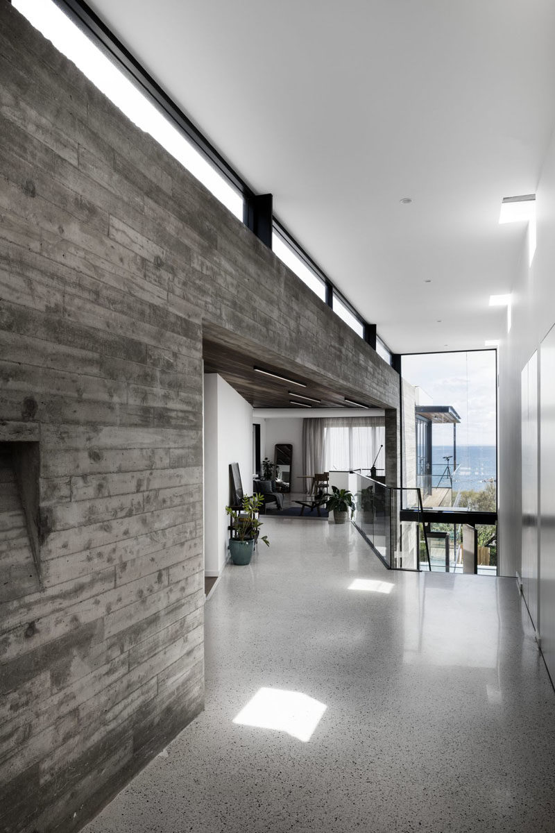 From the front door, this modern house opens up to an entryway with high ceilings and views of the ocean. #Entryway #HighCeilings