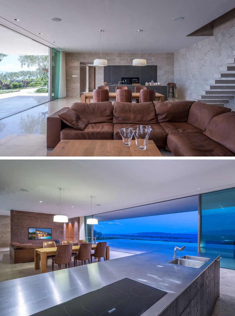 Inside this modern house, the living room, dining room and kitchen all share the same space, while marble has been used throughout the interior walls and floor. #InteriorDesign #ModernHouse