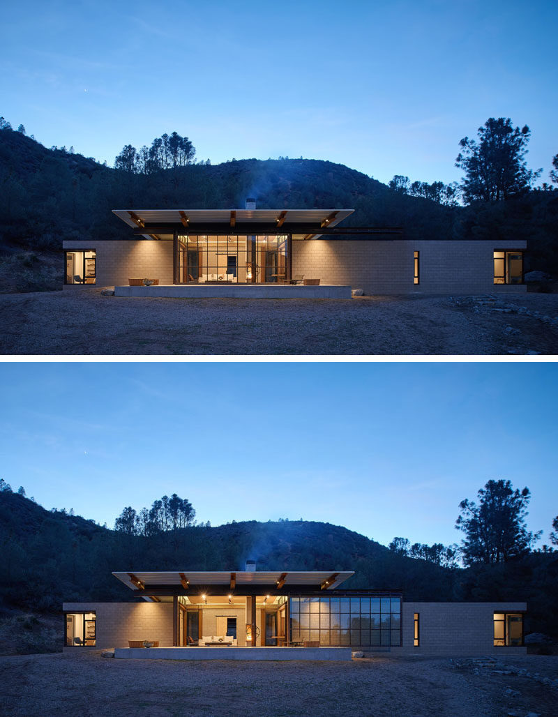 This modern house has a retractable glass that wall helps to create an indoor/outdoor environment, and the roof line extends to provide shade and shelter over the concrete patio. #RetractableWall #GlassWall #ModernHouse #Architecture