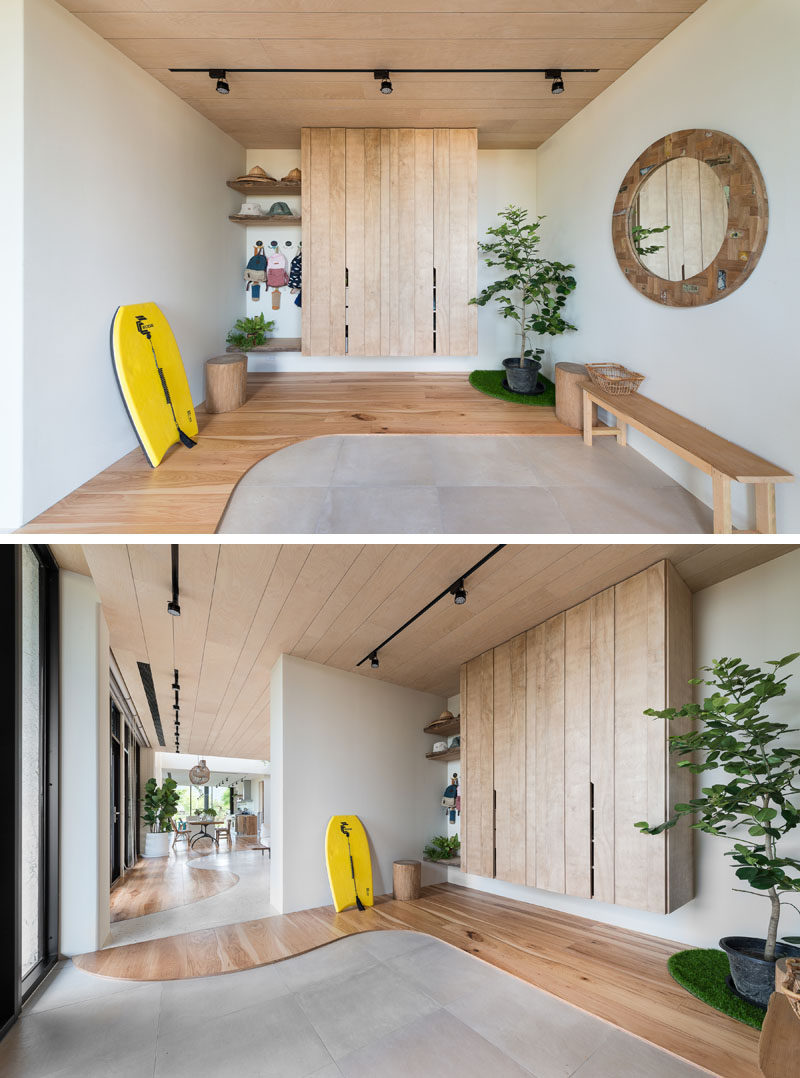 Stepping inside this contemporary house and there's a entryway with open shelving, a closet,and a bench. #Entryway #Foyer #ContemporaryInterior #InteriorDesign