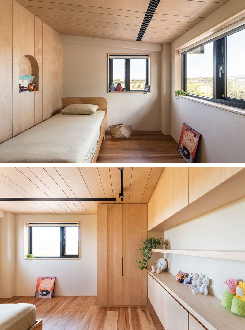 In this modern child's bedroom, a small alcove has been cut out from the wall, while built-in wood cabinets and shelving runs along the wall. #KidsBedroom #BedroomDesign