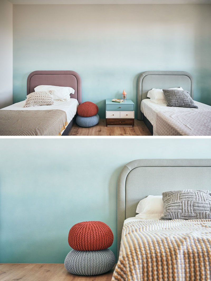 This modern bedroom features a soft colored accent wall. #ModernBedroom #BedroomDesign