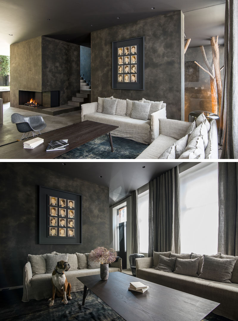 This contemporary living room has a fireplace and windows that look out towards the street. #LivingRoom #Fireplace