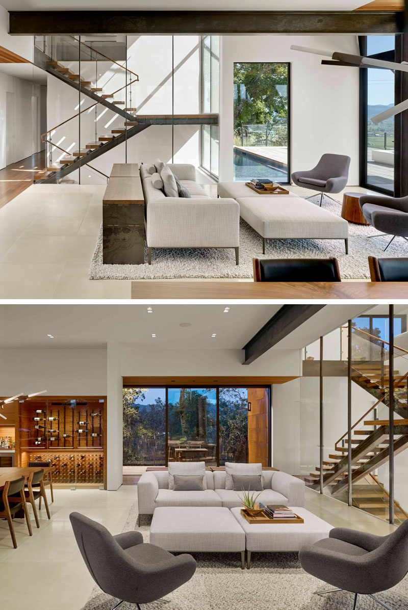 Inside this modern house, light colored walls and plenty of windows help to keep the living room bright and airy, while exposed steel beam give a slight industrial feel to the interior. #LivingRoom #InteriorDesign