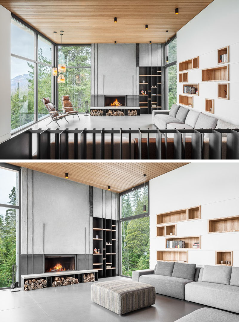 This modern living has built-in wood lined shelving above the couch, while on the adjacent wall is addition shelving and a concrete fireplace. #LivingRoom #BuiltInShelving #Fireplace #Windows