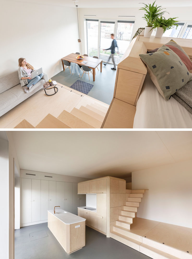 This modern loft apartment has a subtle palette of birch wood and white Corian. There's a bathroom, storage room, kitchen, raised living room, and a lofted bedroom. #InteriorDesign #ApartmentDesign #Loft