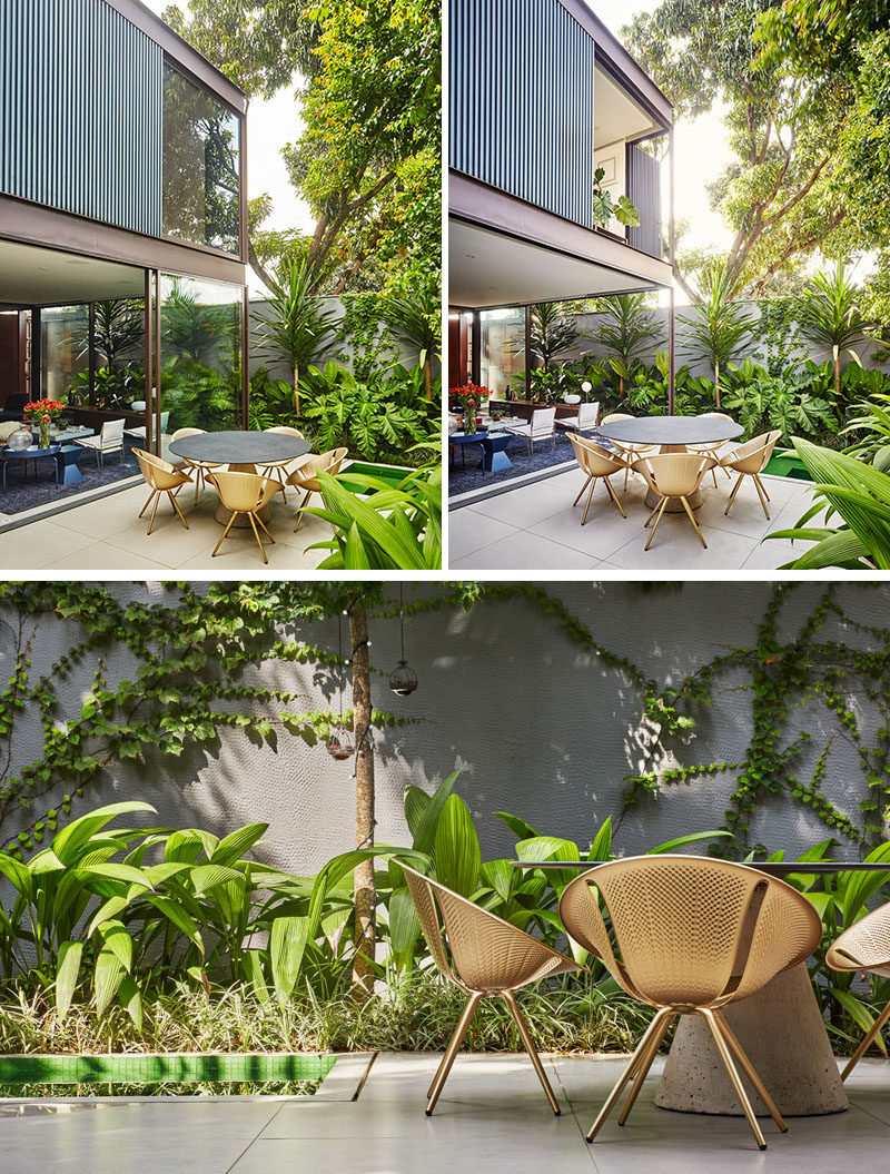 The second floor of th is modern house appears to almost float above the main floor, when the sliding glass doors are open. Tropical landscaping has been used to soften the concrete privacy walls. #ModernHouse #TropicalLandscaping #LandscapeDesign