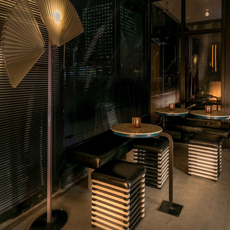 This modern Japanese restaurant interior has a small seating area with casual tables, benches, and stools. #Seating #RestaurantDesign