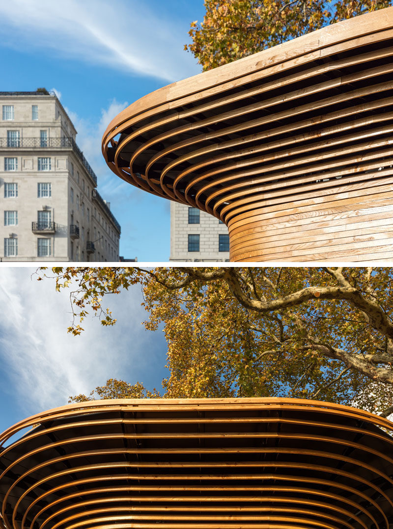 This modern park kiosk features a 360-degree wood sculptural canopy that swells out like a tree’s crown creating a recognizable silhouette within the park. #Architecture #ParkKiosk #Wood