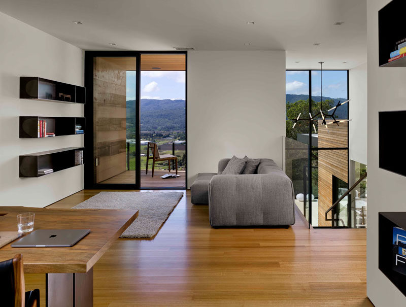 At the top of the stairs in this modern house, is an open home office and sitting room with access to a balcony. #HomeOffice #SittingRoom #Balcony