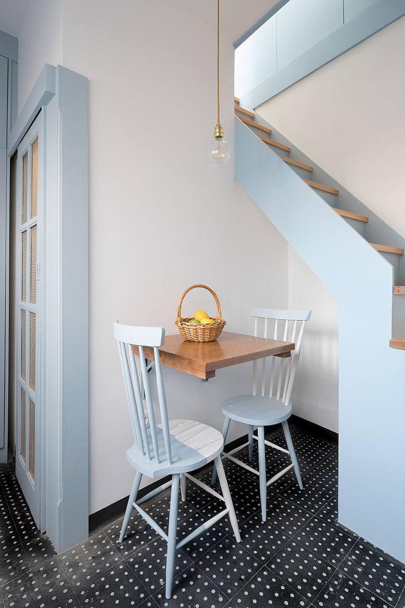 This small dining area for two partially tucks into an alcove underneath the stairs. #Dining #SmallLiving #TinyHouse