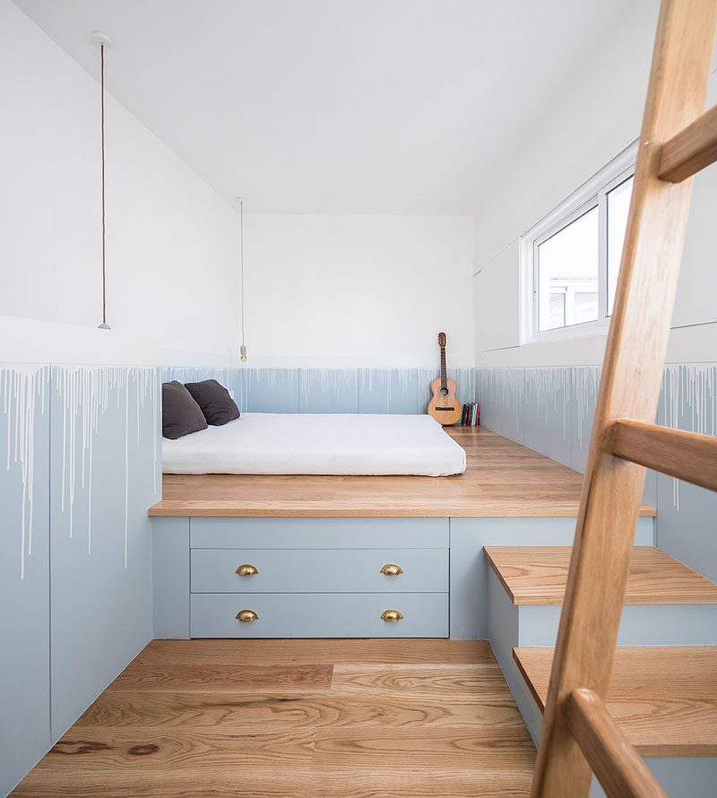 The bed has been raised up onto a custom-designed wood platform, that provides much needed storage in this tiny house. #PlatformBed #BedroomDesign