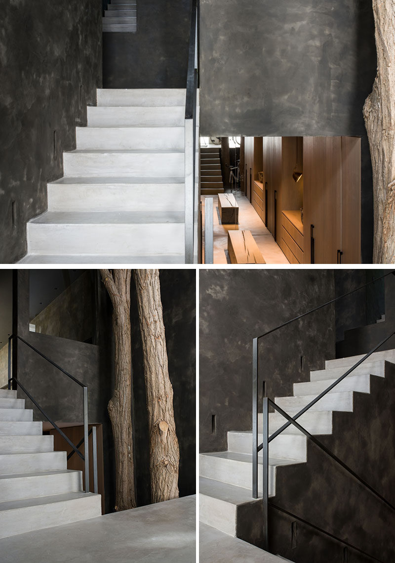 Light colored stairs by the front door of this modern home connect the multiple levels of the house, and contrast the dark walls. #Stairs #StairDesign