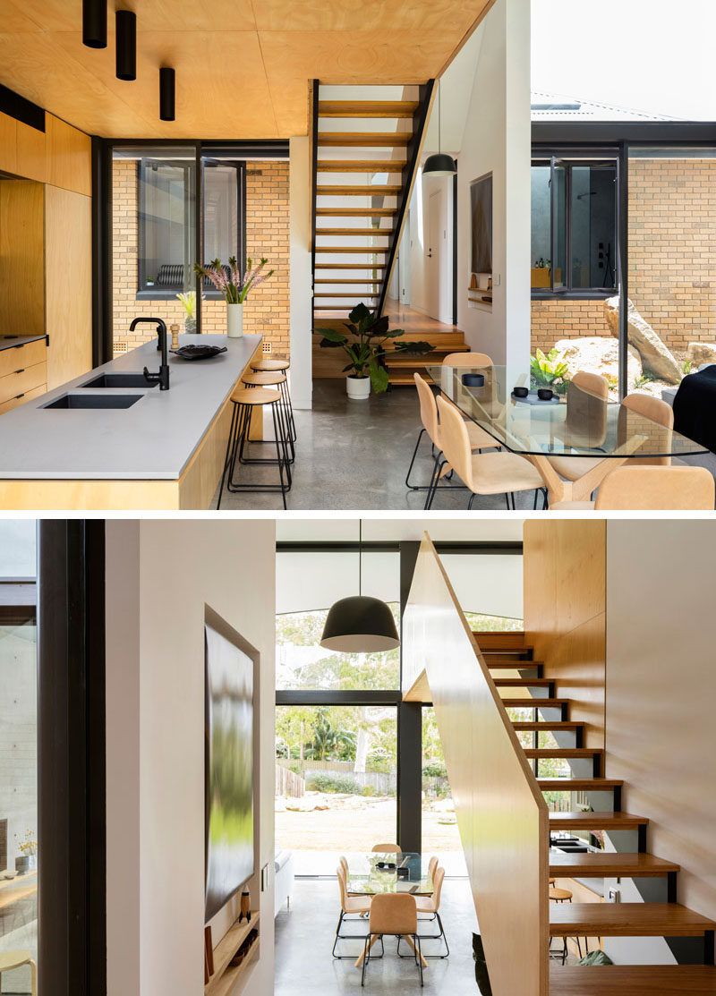 Wood and steel stairs off the hallway lead up to a lofted area above the kitchen in this modern house extension. #Stairs #WoodStairs