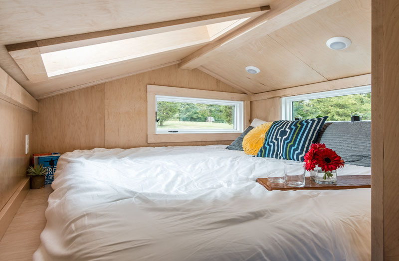 This modern tiny house has a lofted space with a king-size bed. #TinyHouse #Bedroom