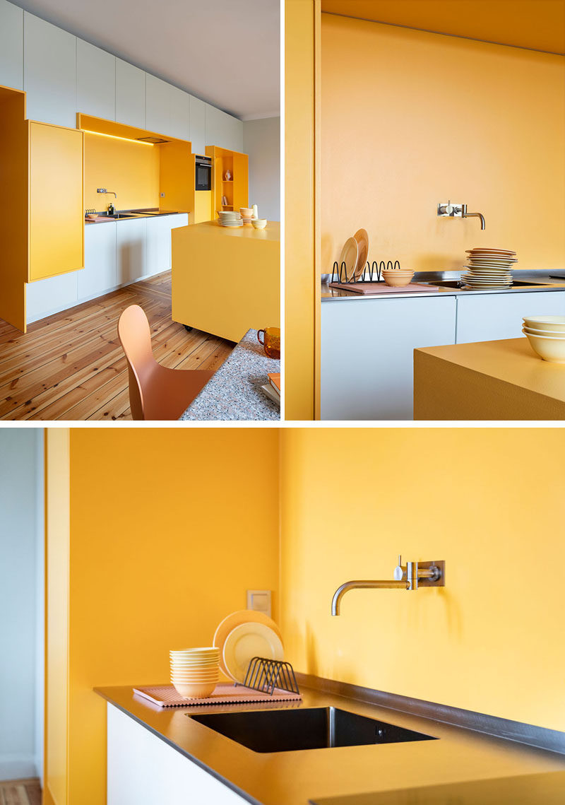 This renovated 1920s apartment in Stockholm received a modern makeover, with a custom designed wall that includes yellow built-in sections that house a kitchen and a seating nook. #InteriorDesign #Kitchen #SeatingNook