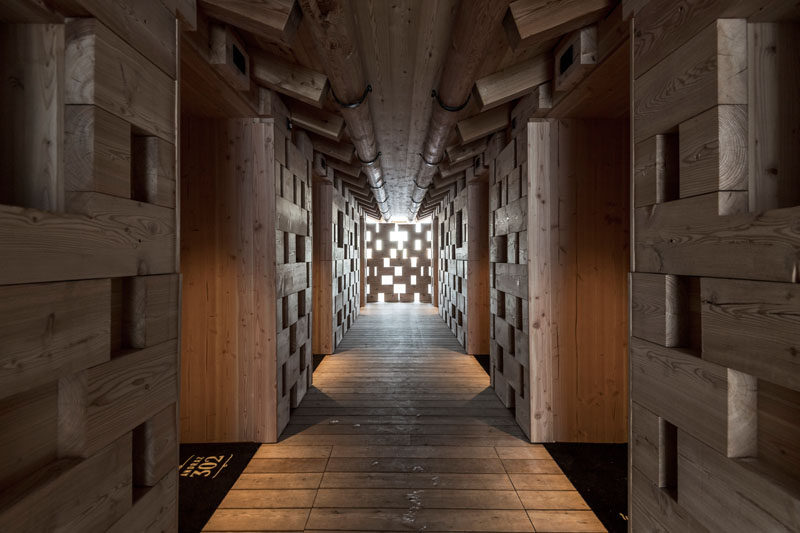 The wooden hallway of this hotel, that show off the woodwork used in building the huts, leads to the rooms. #Architecture #Wood