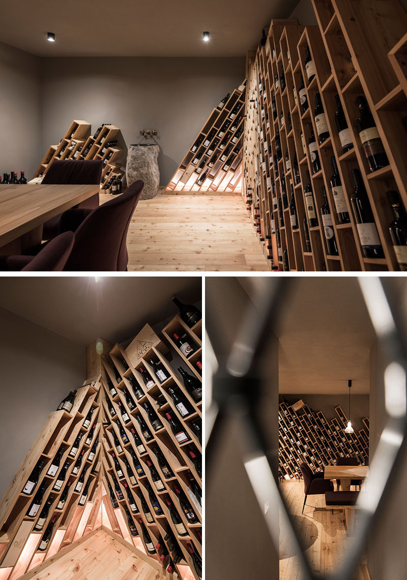 The design of this hotel's wine cellar is inspired by the mountains, and has wood shelving installed on an angle, with compartments for individual bottles of wine. #WineCellar #WineStorage