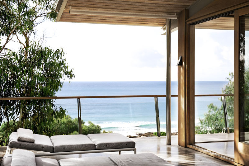 The social areas of this modern house open to a balcony that shows off the ocean views. #Balcony #ModernHouse