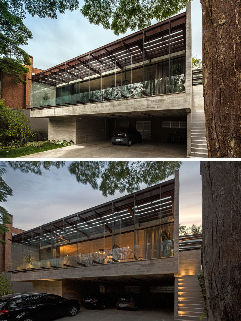 Pivoting glass panels proving a unique facade for this modern house, while lighting guides visitors to the front door. #ModernHouse #ExteriorLighting #Windows