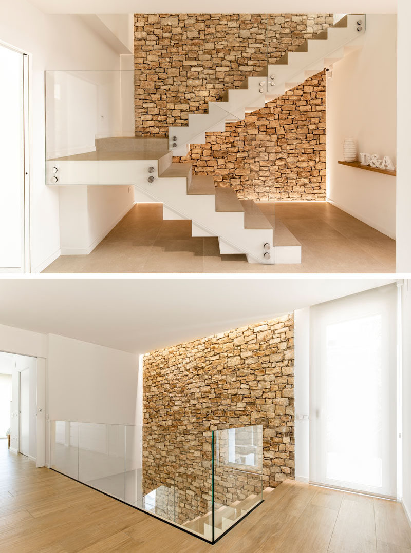 An accent stone wall has also been included inside this modern home, creating a natural backdrop for the staircase. #StoneWall #Stairs #Staircase