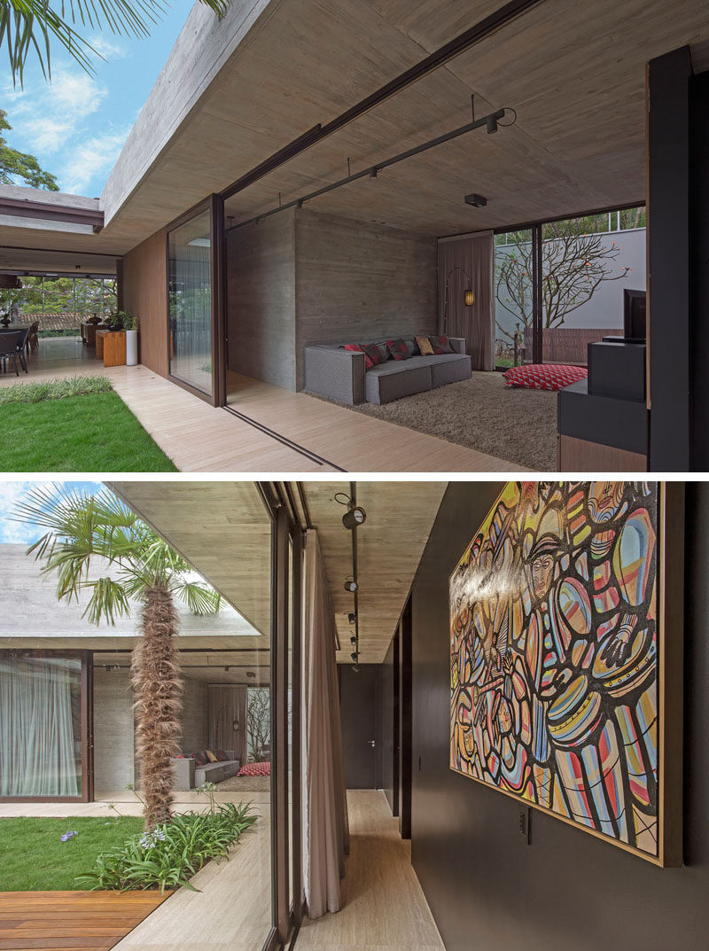 A hallway that lines the courtyard of this modern house connects the social areas of the home with the bedrooms. #LivingRoom #Hallway