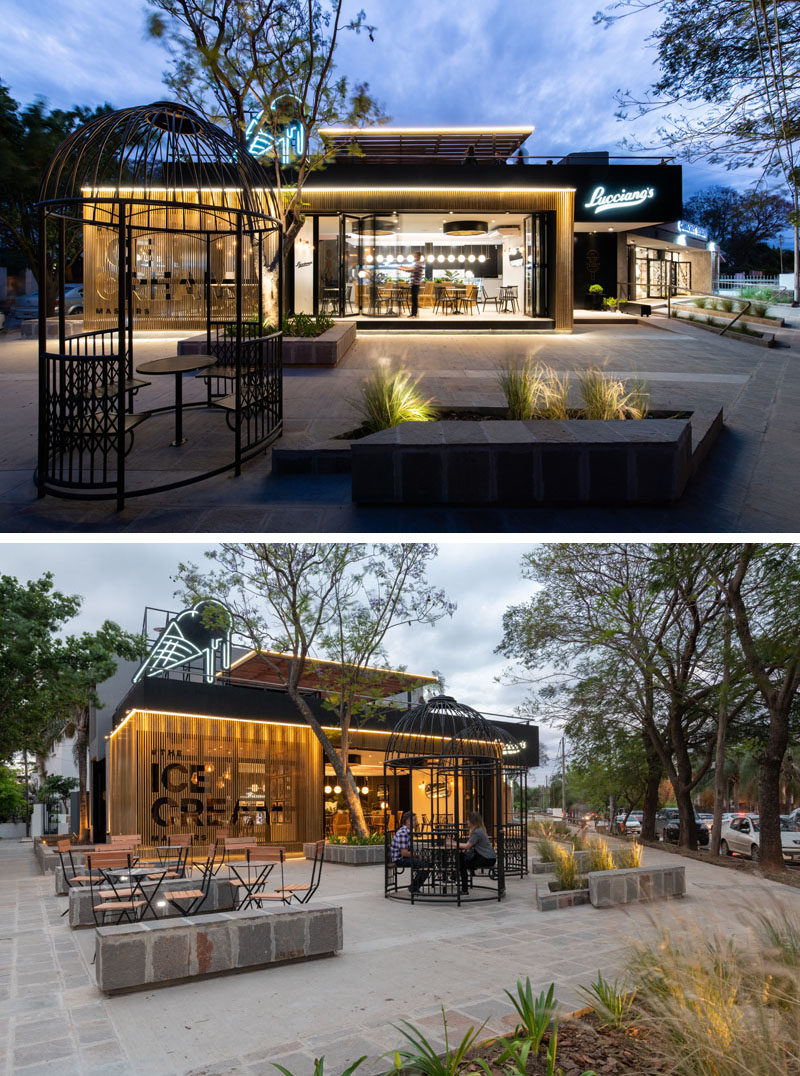 This modern cafe has an outdoor seating area that features two giant iron bird cages, that allow for a unique seating experience. #CafeDesign #Architecture