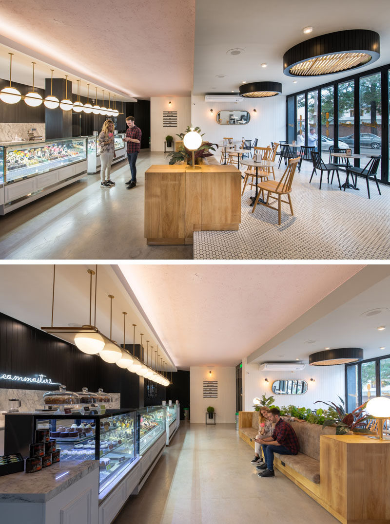 Inside this cafe, a split level creates designated areas for seating and ordering. Floor-to-ceiling folding glass doors can be opened to connect the seating area to the patio outside, while on the lower level, a long couch gives people a place to wait for their order. #Cafe #RetailDesign #Seating