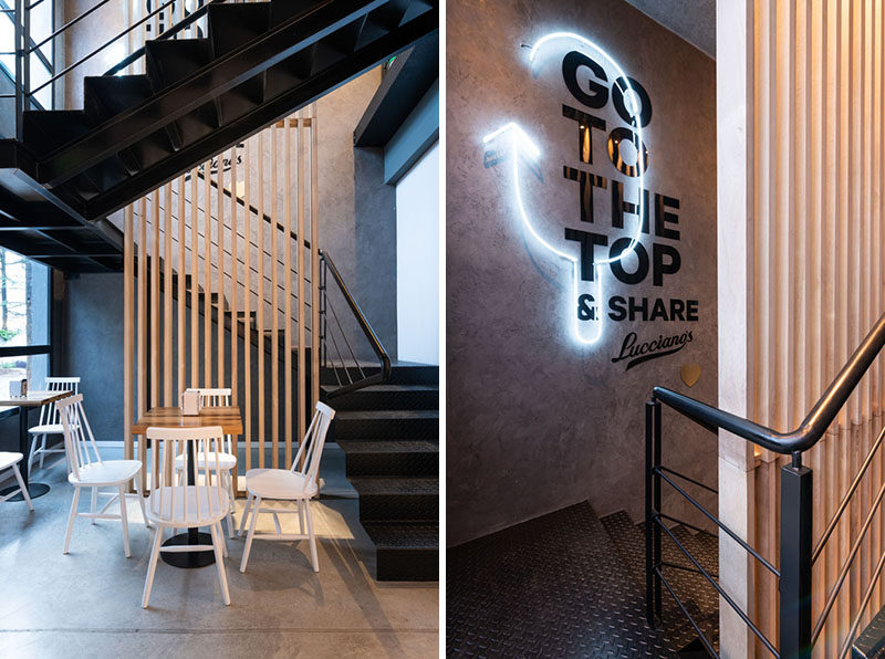 This modern cafe features Black steel stairs with a wood accent and neon lighting, that guide customers up to the rooftop. #Stairs #Cafe #NeonLighting