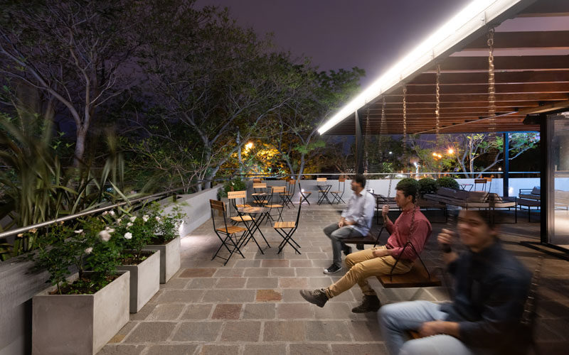 The rooftop of this ice cream cafe offers further seating, like swings, tables and chairs, and couches, with a view of the neighborhood. #RooftopSeating #Restuarant